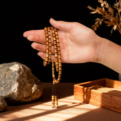 Holding the sandalwood bamboo bracelet, feeling its initially textured then silky surface that deepens with wear into a jade-like glow.