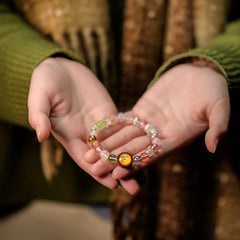 Gently cradling the Conch crystal bracelet in both hands, receiving its blessings as a spiritual tool for peace and clarity from BodhiPulse.