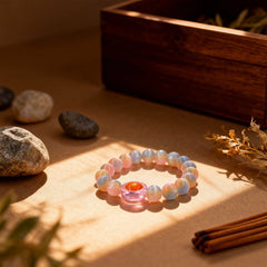 The ‘Heavenly Wisdom’ bracelet on a table, light illuminating its golden gradient colors and intricate flowing patterns in the rabbit hair crystal.
