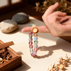 The ‘Radiant Embrace’ multicolored glass bracelet dangling, its shifting hues capturing the dynamic, fluid beauty of the sky and auspicious energy.
