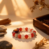 The ‘Quiet Warmth’ bracelet on a table, light revealing the crystalline patterns of red and white rabbit fur crystals, symbolizing gentle harmony.