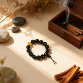 Natural soapberry bracelet from BodhiPulse on a wooden table, crafted from fruits gathered near ancient practice grounds for pure energy.