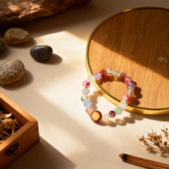 Flat lay of the 19-bead colorful glass bracelet, its blended colors symbolizing harmony and the nurturing energy of the sky from BodhiPulse.