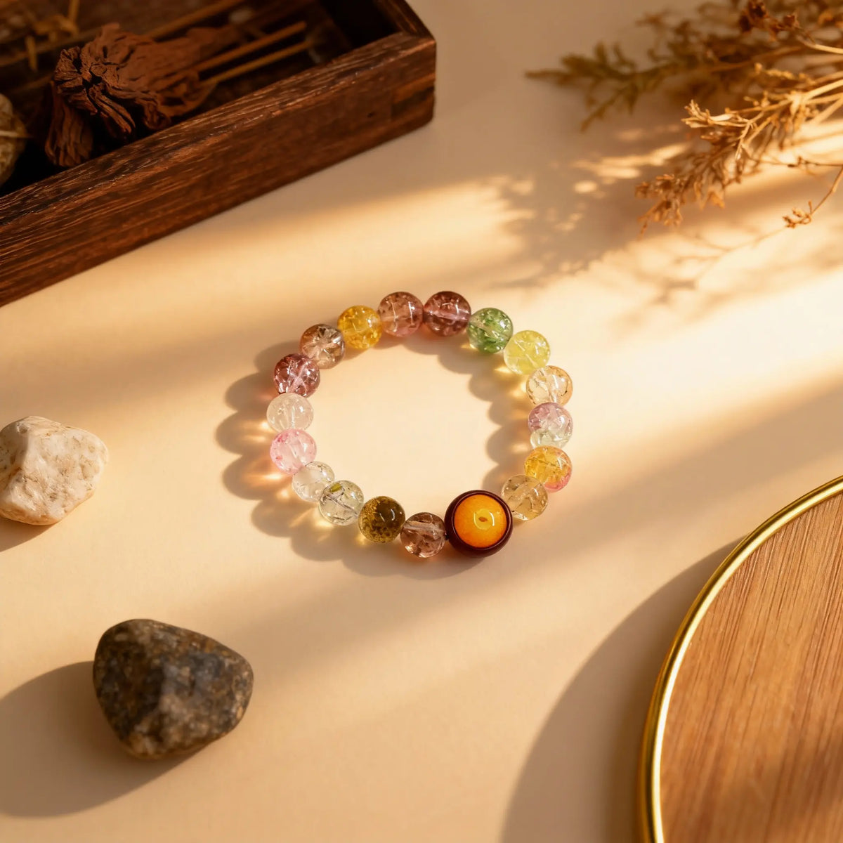 Flat lay of the 20-bead ‘Eternal Glow’ bracelet by BodhiPulse, showcasing the harmonious blend of amber-toned and vibrant translucent glass beads.
