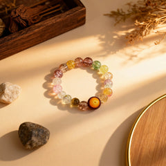 Flat lay of the 20-bead ‘Eternal Glow’ bracelet by BodhiPulse, showcasing the harmonious blend of amber-toned and vibrant translucent glass beads.