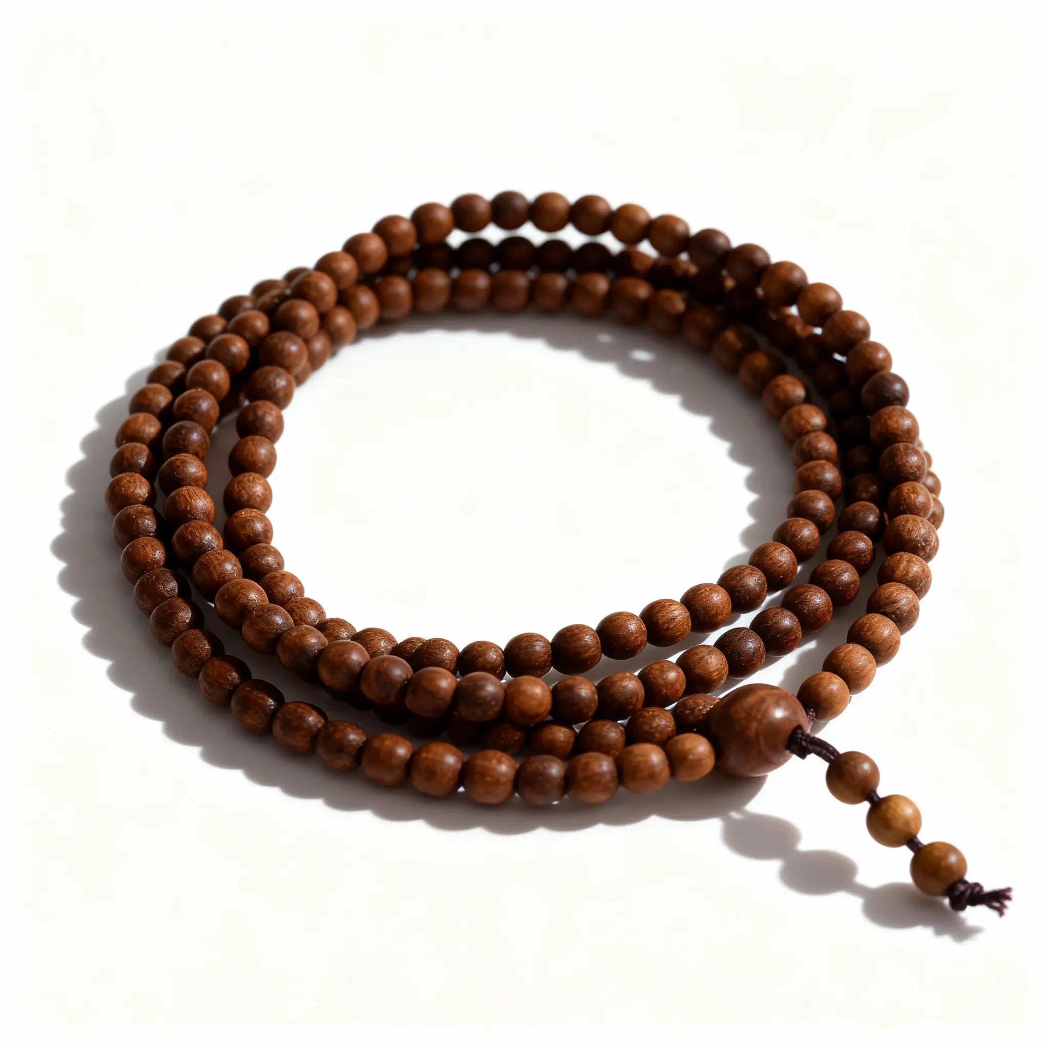 BodhiPulse ‘Overlapping Universes’ multi-loop sandalwood mala shown in a triple-loop stack, representing layered time and cyclical return.
