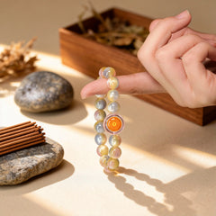 The 17-bead ‘Heavenly Wisdom’ bracelet dangling, its golden rabbit hair crystal catching light to symbolize the gentle flow of cosmic energy.