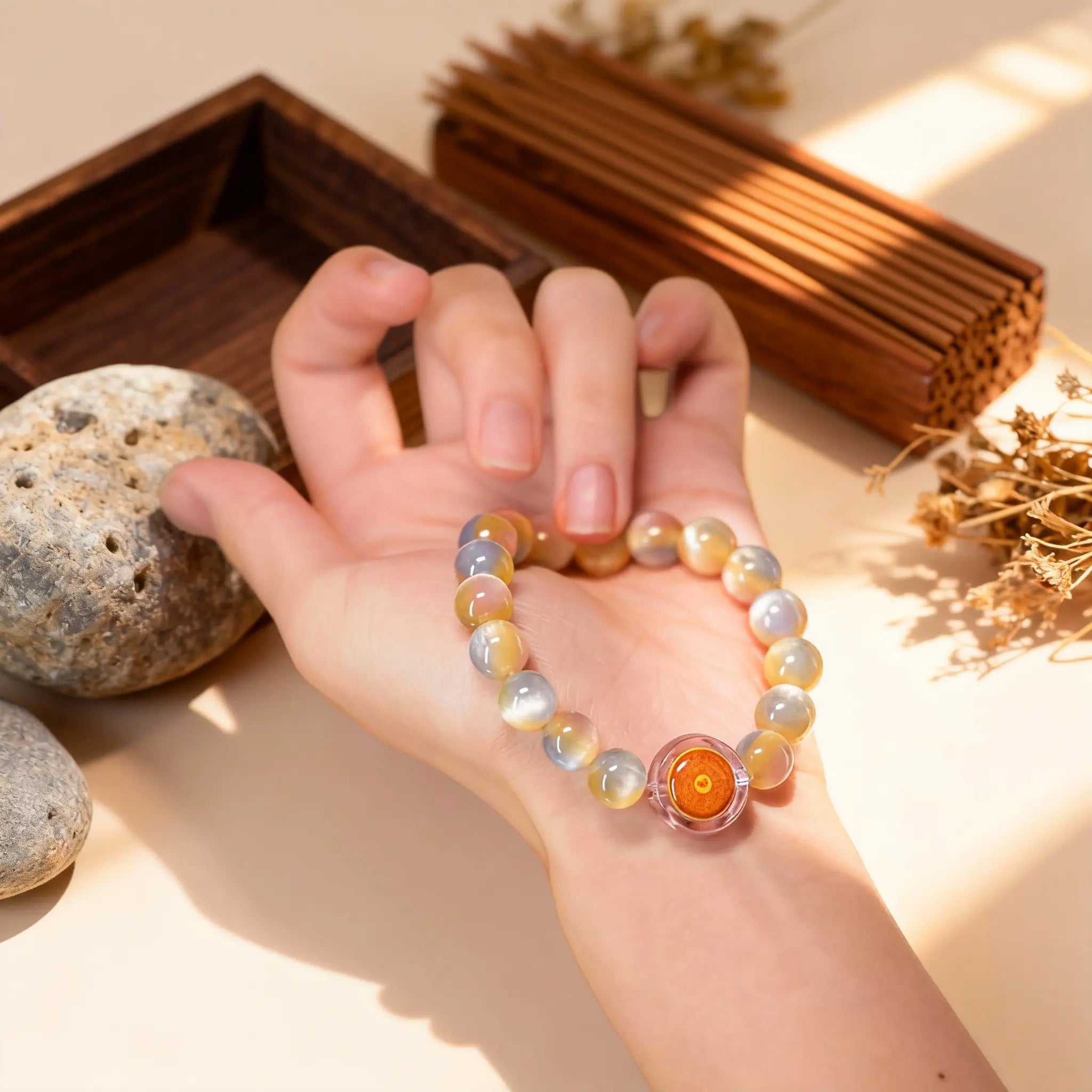 Holding the ‘Heavenly Wisdom’ rabbit hair crystal bracelet in hand, a BodhiPulse talisman for connecting to inner peace and higher self.