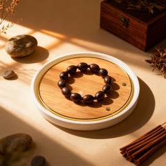 Natural wooden mala with ancient lotus seeds placed on a wooden table, promoting grounding energy