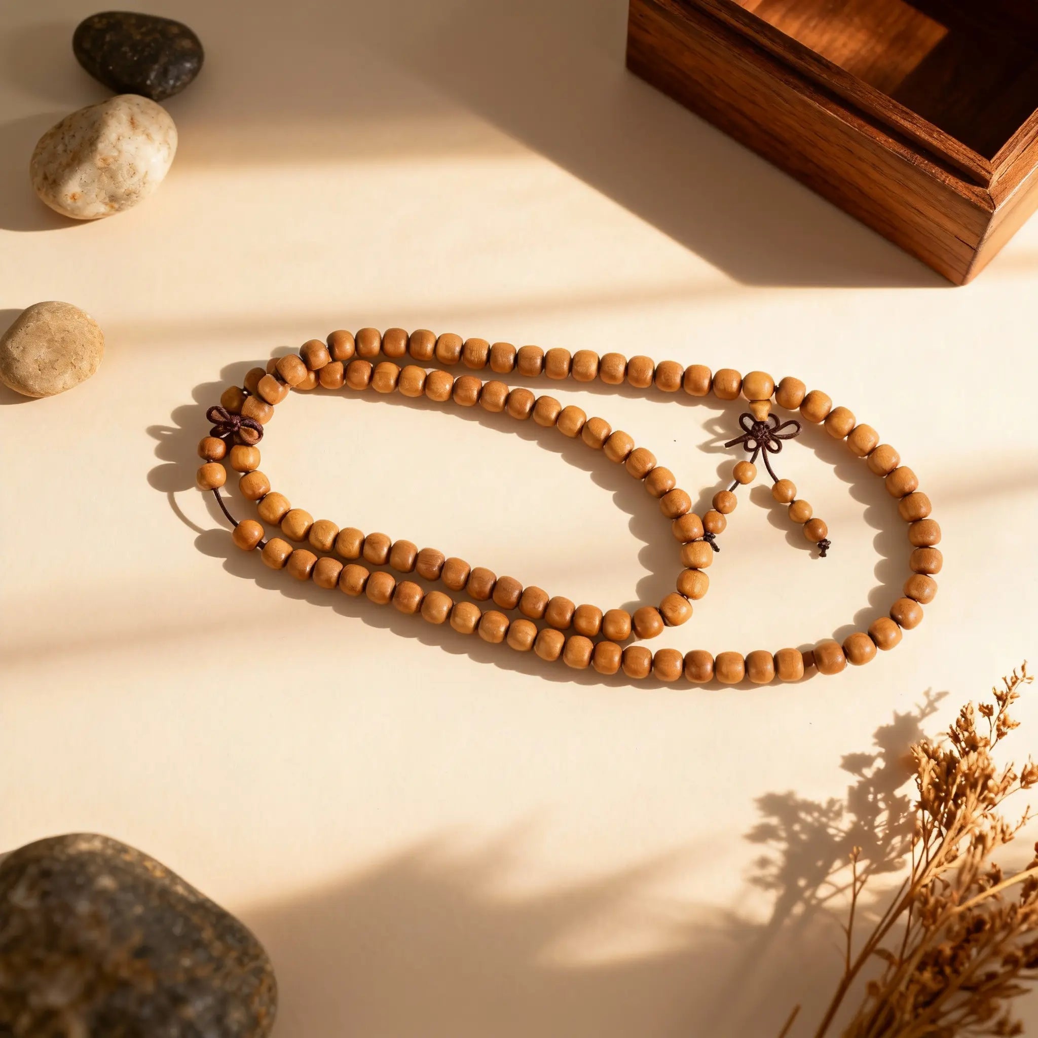 The 108-bead sandalwood bracelet arranged in its layers, embodying a steady boundary and a return to inner peace.