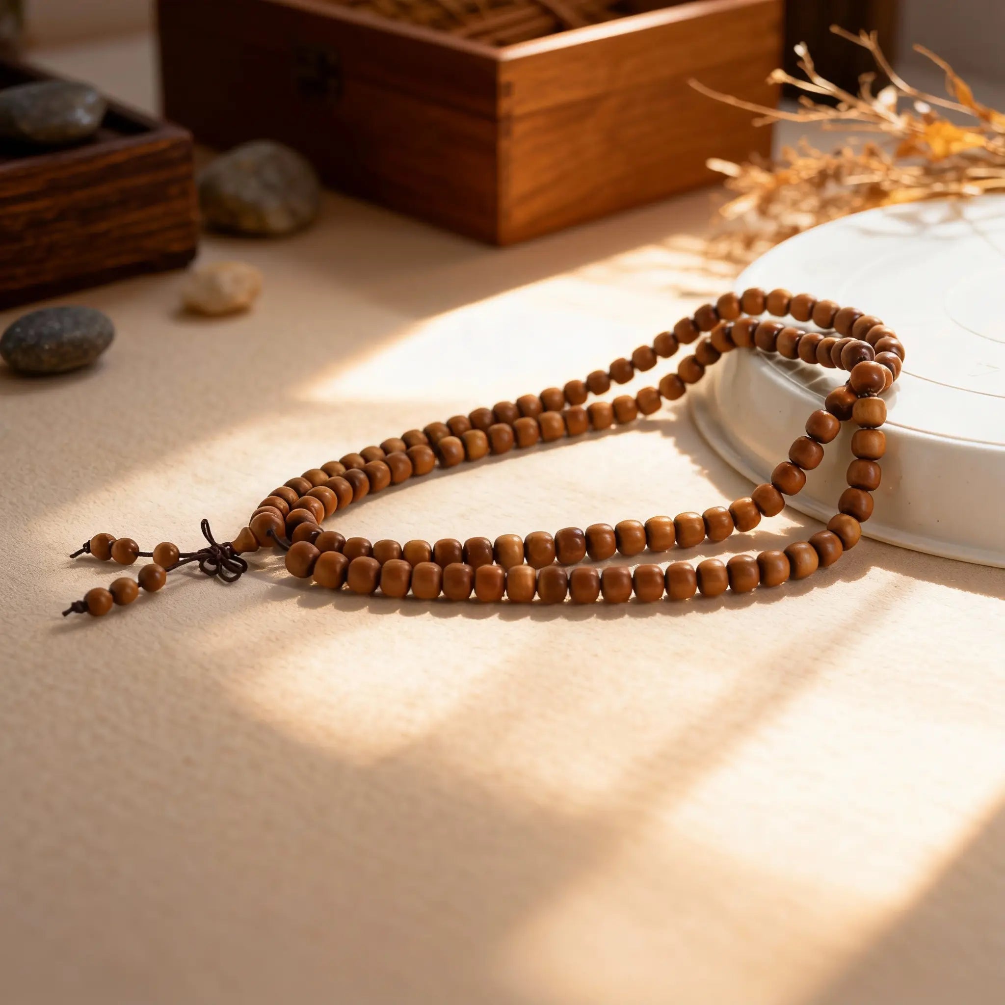 Handmade Indian sandalwood bracelet, its aged wood releasing a subtle fragrance for grounding and calming scattered thoughts.